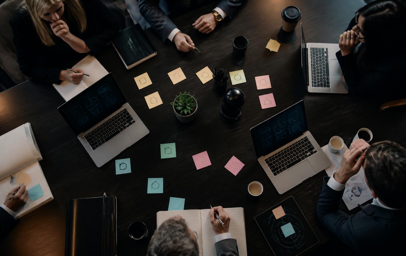Executive team mapping AI use cases around a boardroom table